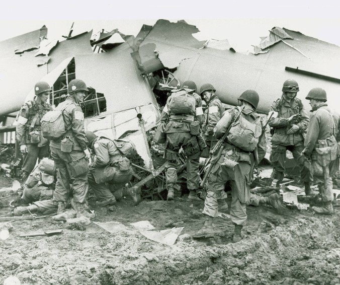 101st Airborne Division troops that landed behind German lines in Holland examine what is left of one of the gliders